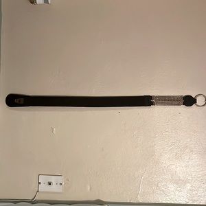 Accessory belt primarily black with stylish gold accents